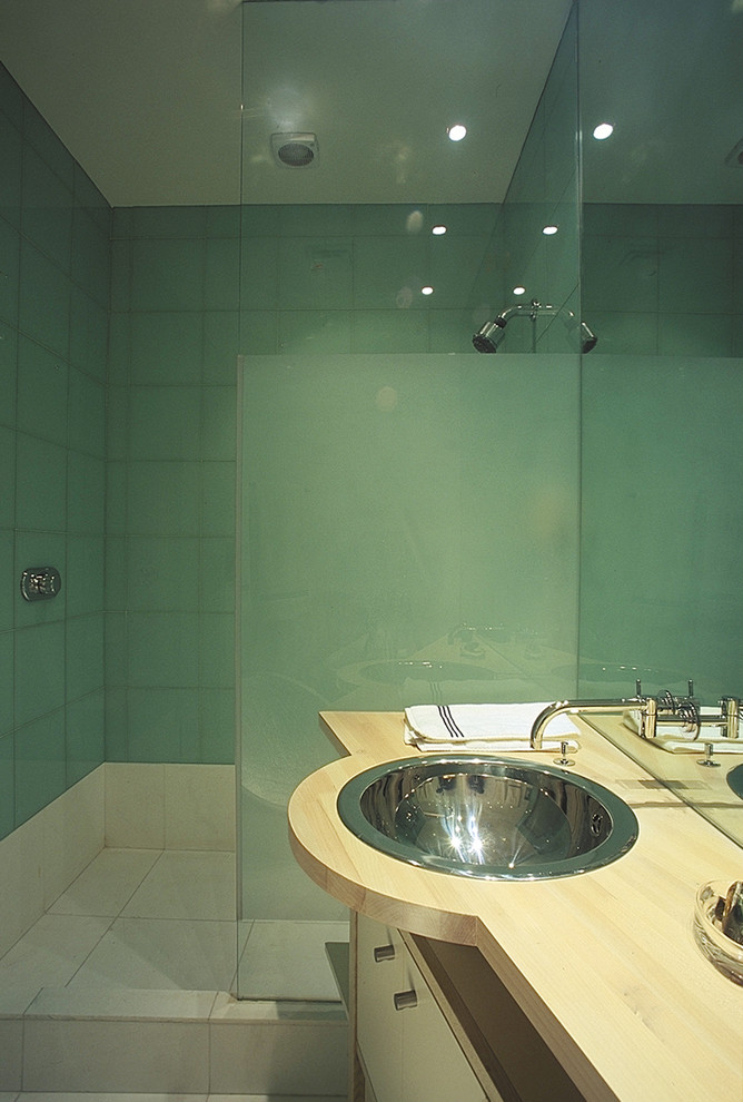Contemporary bathroom in Other with a drop-in sink and green tile.