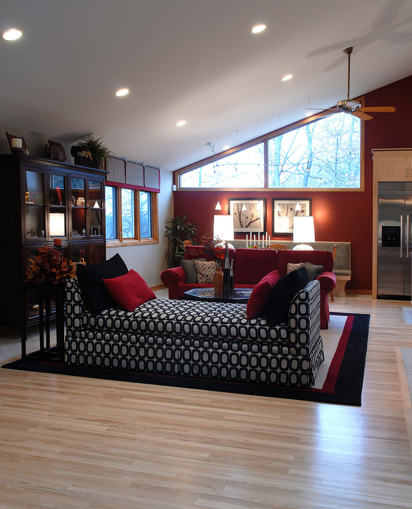 This is an example of a mid-sized contemporary formal living room in Chicago with light hardwood floors, brown floor and vaulted.