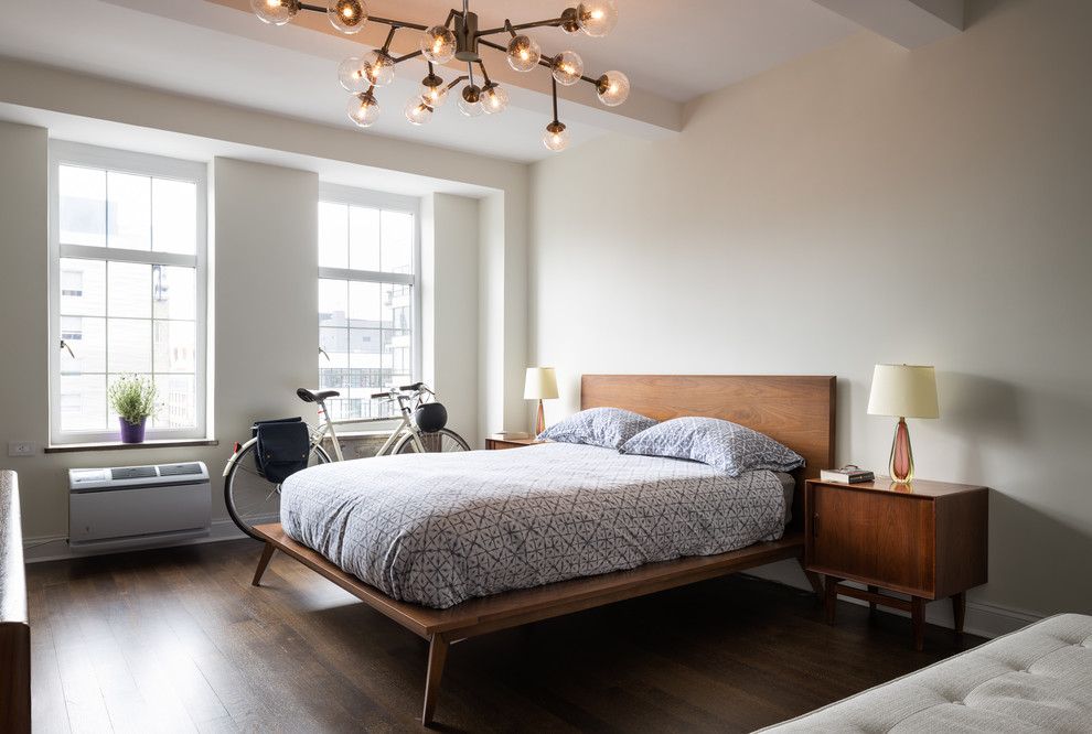 Mid-sized contemporary master bedroom in New York with grey walls, dark hardwood floors and brown floor.