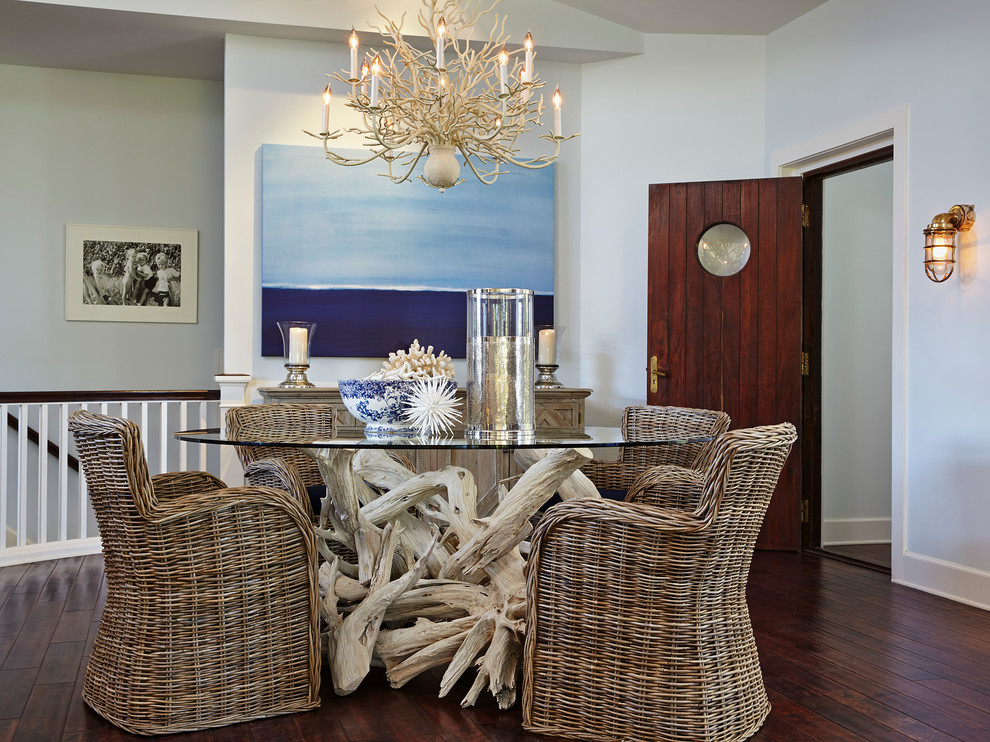Inspiration for a mid-sized beach style dining room in Miami with grey walls, dark hardwood floors, no fireplace and brown floor.