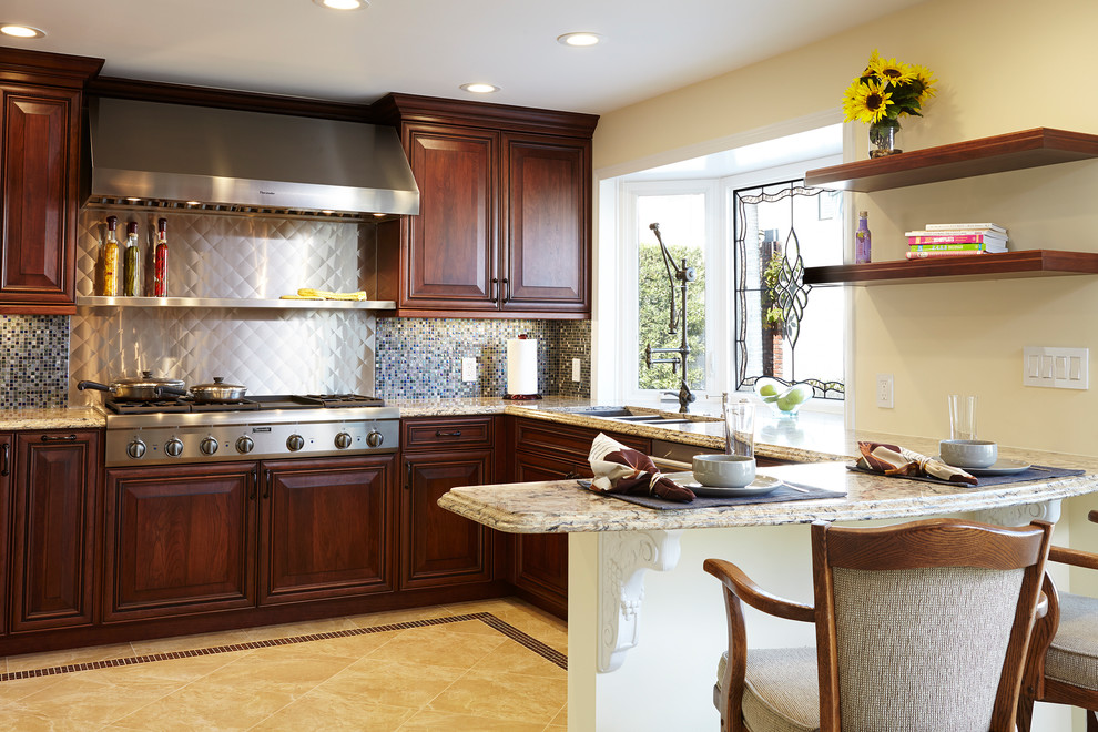 This is an example of a mid-sized traditional u-shaped eat-in kitchen in Los Angeles with a triple-bowl sink, raised-panel cabinets, dark wood cabinets, quartz benchtops, multi-coloured splashback, glass tile splashback, stainless steel appliances, marble floors, a peninsula and beige floor.