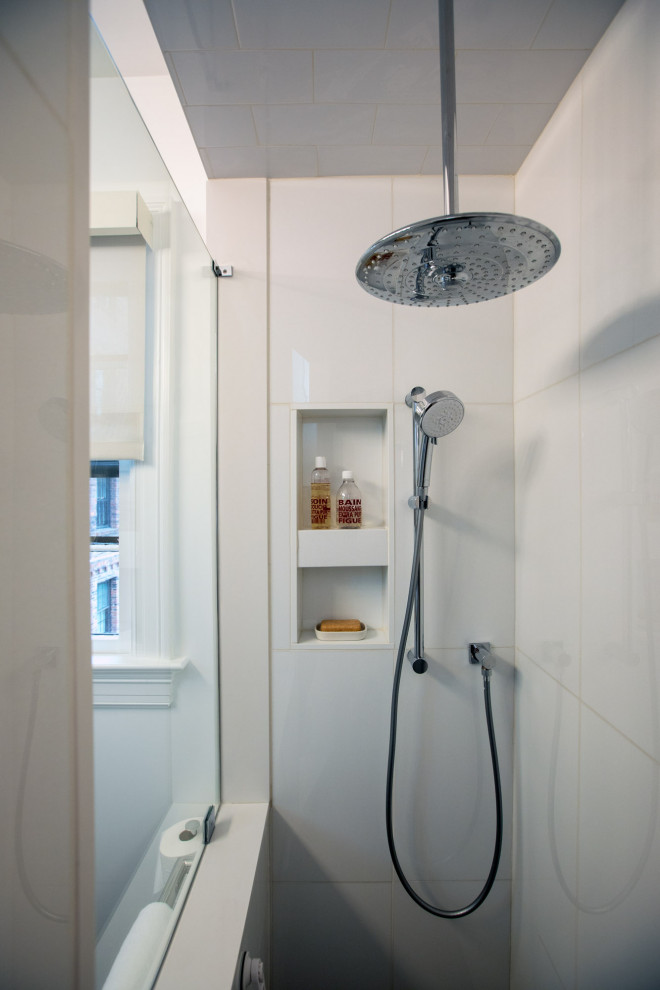 Inspiration for a small modern 3/4 bathroom in Baltimore with flat-panel cabinets, white cabinets, a corner shower, a two-piece toilet, white tile, porcelain tile, grey walls, ceramic floors, a wall-mount sink, solid surface benchtops, grey floor, an open shower, white benchtops, a shower seat, a single vanity, a floating vanity, recessed and decorative wall panelling.
