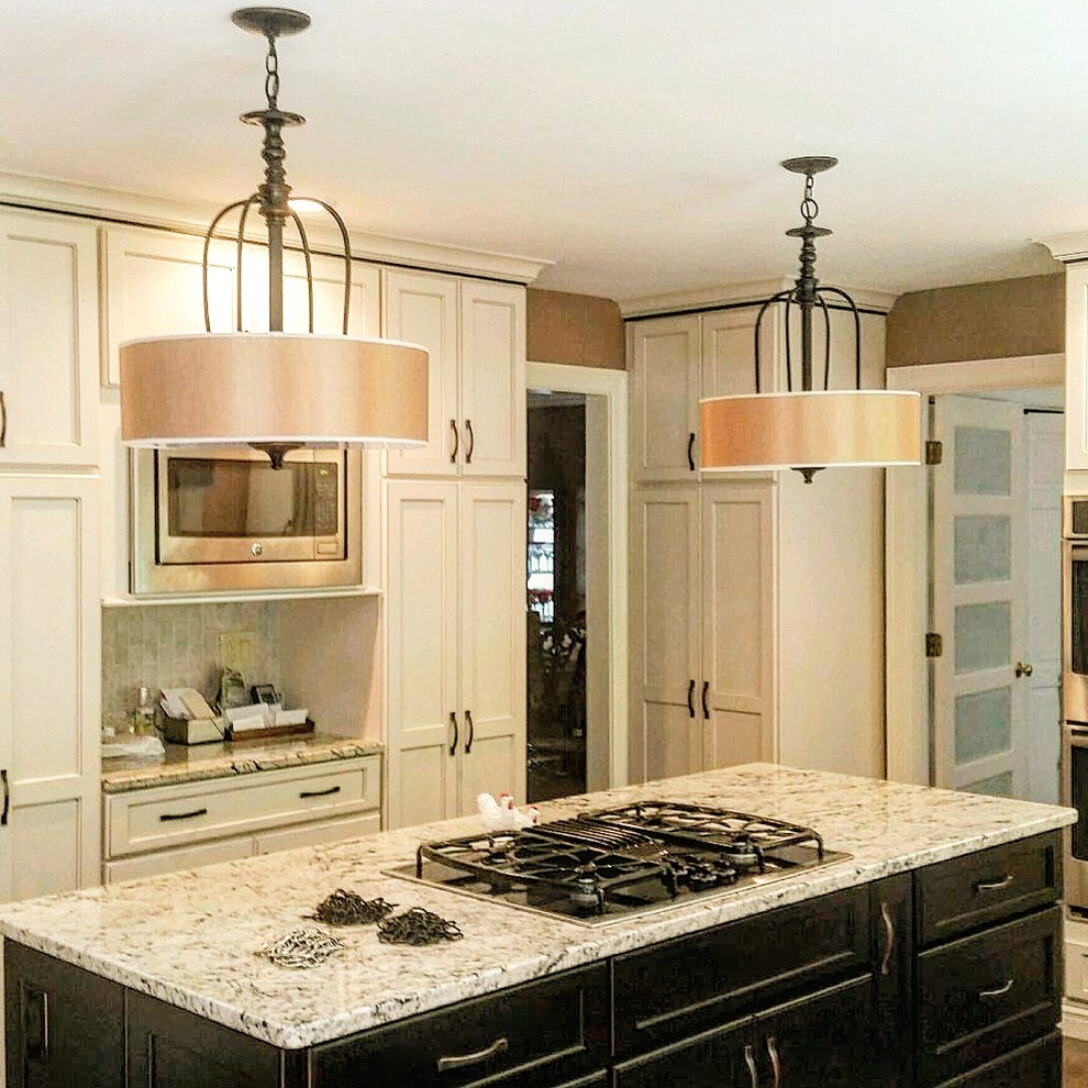 Inspiration for a mid-sized timeless u-shaped dark wood floor and brown floor eat-in kitchen remodel in Boston with raised-panel cabinets, beige cabinets, granite countertops, porcelain backsplash, stainless steel appliances, an island and multicolored countertops