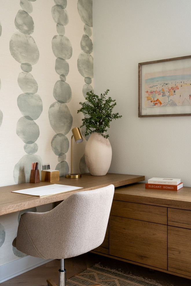 Tuscan built-in desk light wood floor, wallpaper and beige floor home office photo in Los Angeles with multicolored walls