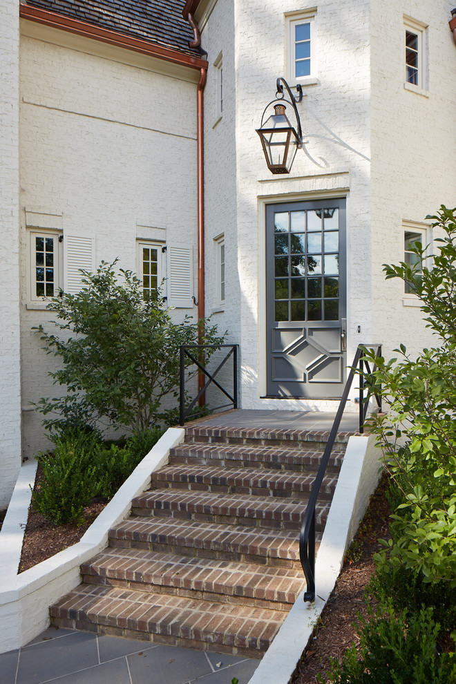 Photo of a modern entryway in Charlotte with white walls, a single front door and a blue front door.
