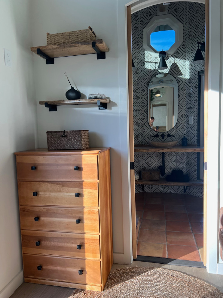 Small country light wood floor, beige floor and exposed beam entryway photo in Hawaii with white walls and a glass front door