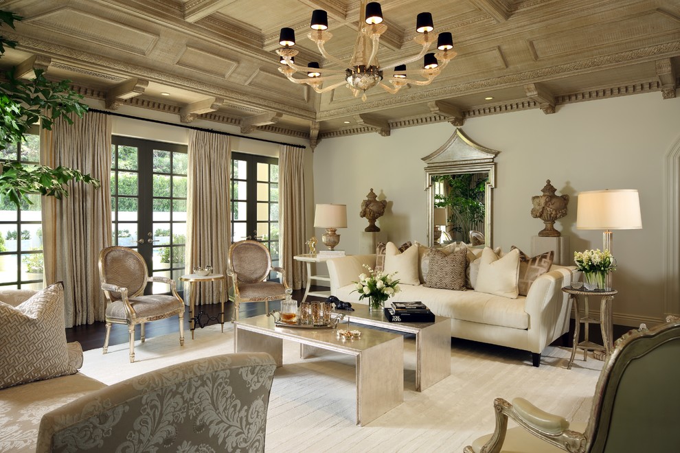 This is an example of a large traditional formal enclosed living room in Los Angeles with no fireplace, a wall-mounted tv, beige walls, dark hardwood floors and brown floor.