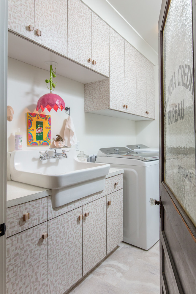 Transitional single-wall dedicated laundry room in Other with an utility sink, flat-panel cabinets, laminate benchtops, white walls, a side-by-side washer and dryer, beige floor and white benchtop.