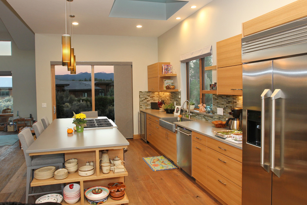 Photo of a mid-sized contemporary single-wall eat-in kitchen in Other with flat-panel cabinets, medium wood cabinets, stone tile splashback, stainless steel appliances, medium hardwood floors and with island.