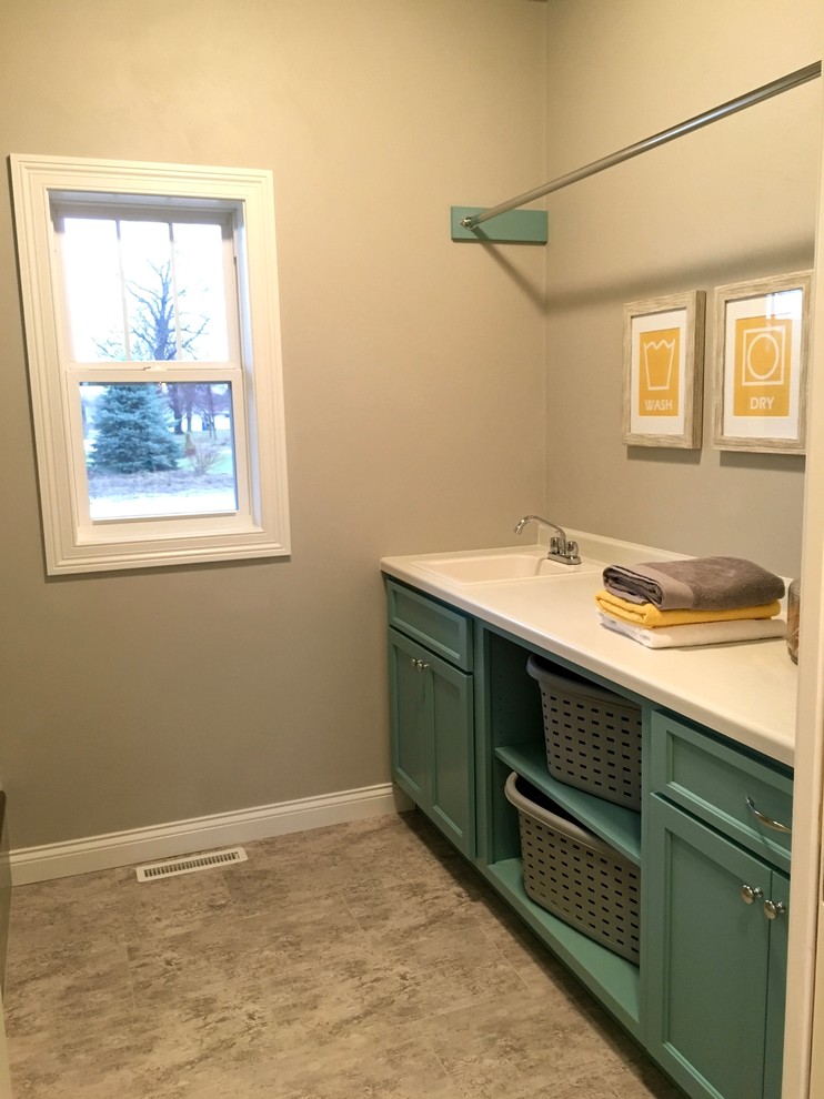 Arts and crafts laundry room in Other with a single-bowl sink, blue cabinets, laminate benchtops, beige walls, ceramic floors and a side-by-side washer and dryer.