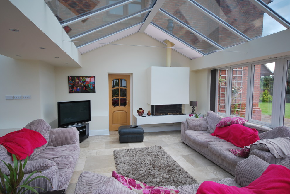 Inspiration for a transitional sunroom in Cheshire with a ribbon fireplace, a glass ceiling and grey floor.