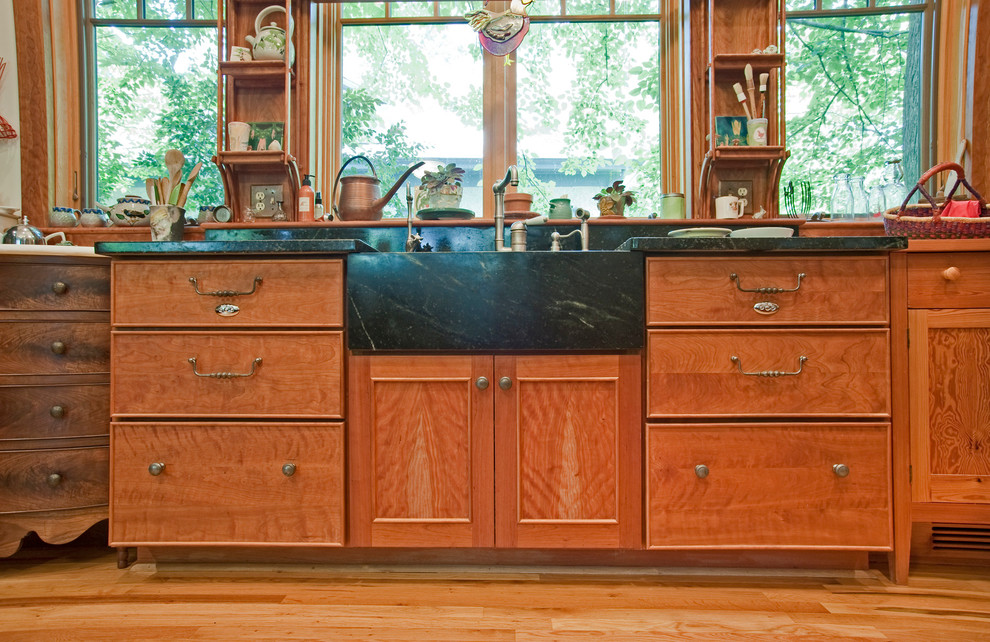 Photo of a mid-sized arts and crafts kitchen in Atlanta with an integrated sink, open cabinets, soapstone benchtops, brown splashback and window splashback.