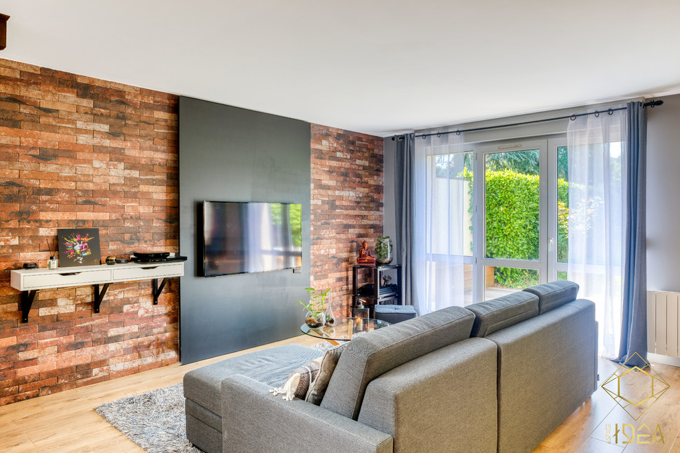 This is an example of an industrial open concept living room in Paris with a wall-mounted tv.