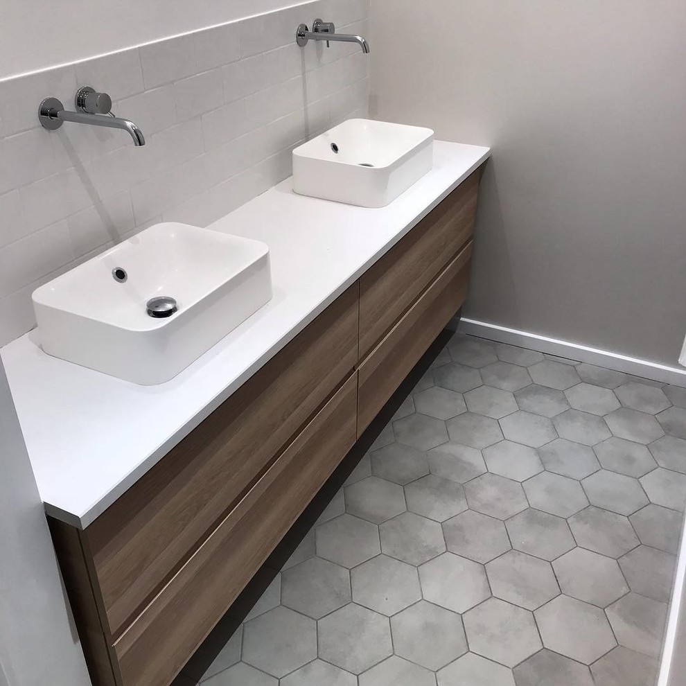 Design ideas for a small 3/4 bathroom in Lyon with light wood cabinets, a curbless shower, a two-piece toilet, white tile, ceramic tile, beige walls, ceramic floors, a drop-in sink, quartzite benchtops, grey floor, a hinged shower door, white benchtops and flat-panel cabinets.