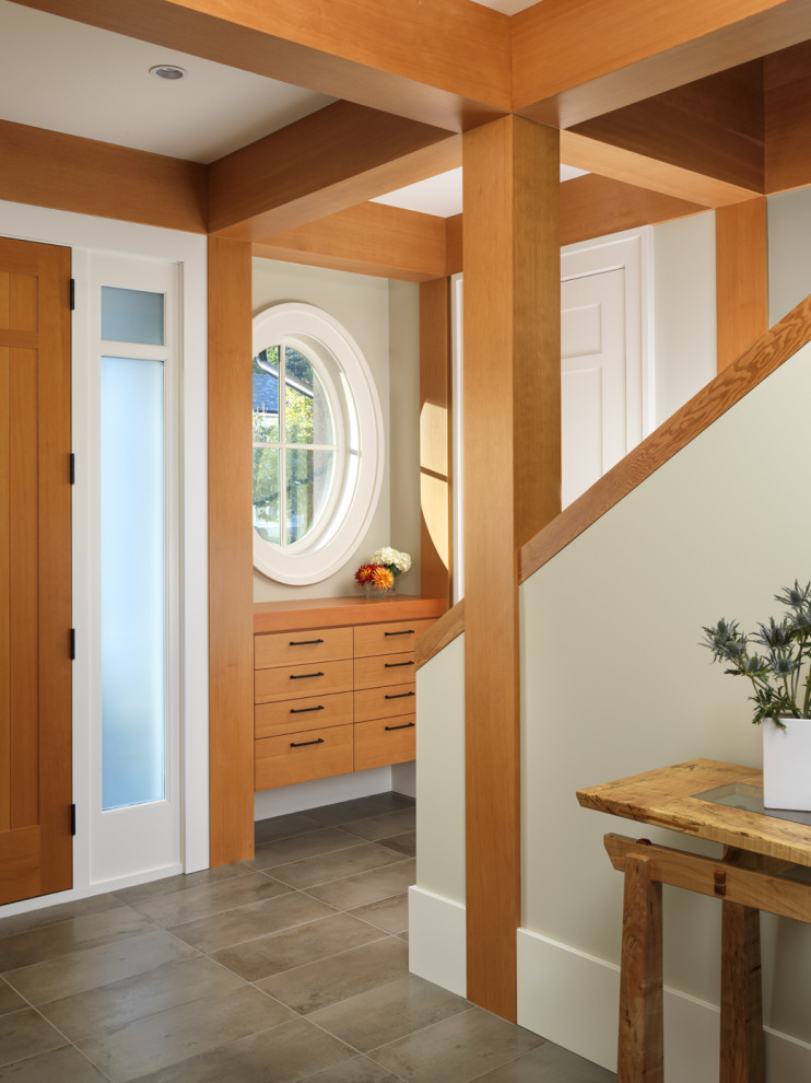Inspiration for a mid-sized transitional porcelain tile and gray floor front door remodel with beige walls and a medium wood front door
