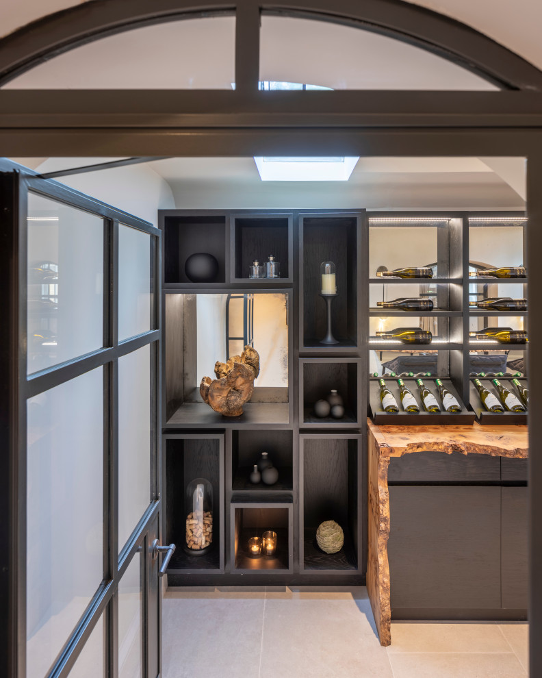 Photo of a large contemporary wine cellar in West Midlands with ceramic floors, display racks and grey floor.