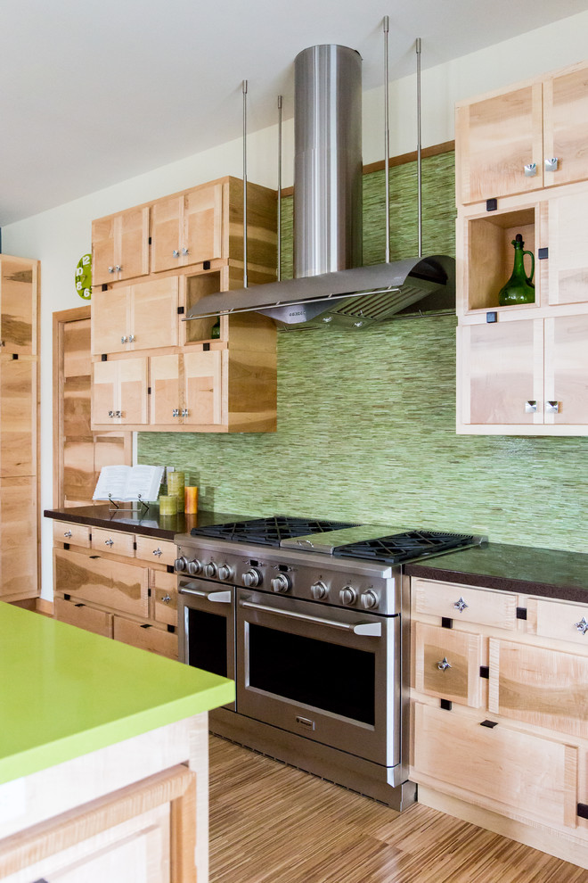 Large transitional u-shaped eat-in kitchen in Salt Lake City with an undermount sink, flat-panel cabinets, light wood cabinets, quartz benchtops, green splashback, mosaic tile splashback, stainless steel appliances, bamboo floors and with island.