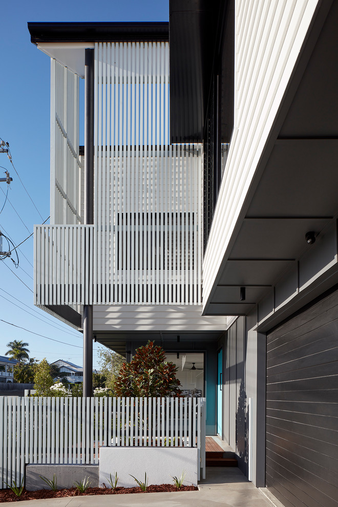 Mid-sized contemporary two-storey white house exterior in Brisbane with a metal roof.