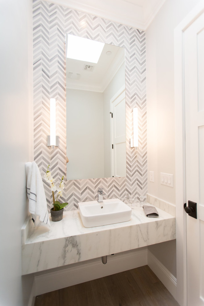 Inspiration for a large contemporary powder room in Phoenix with gray tile, a vessel sink, marble benchtops, grey walls, medium hardwood floors, grey floor, marble and open cabinets.