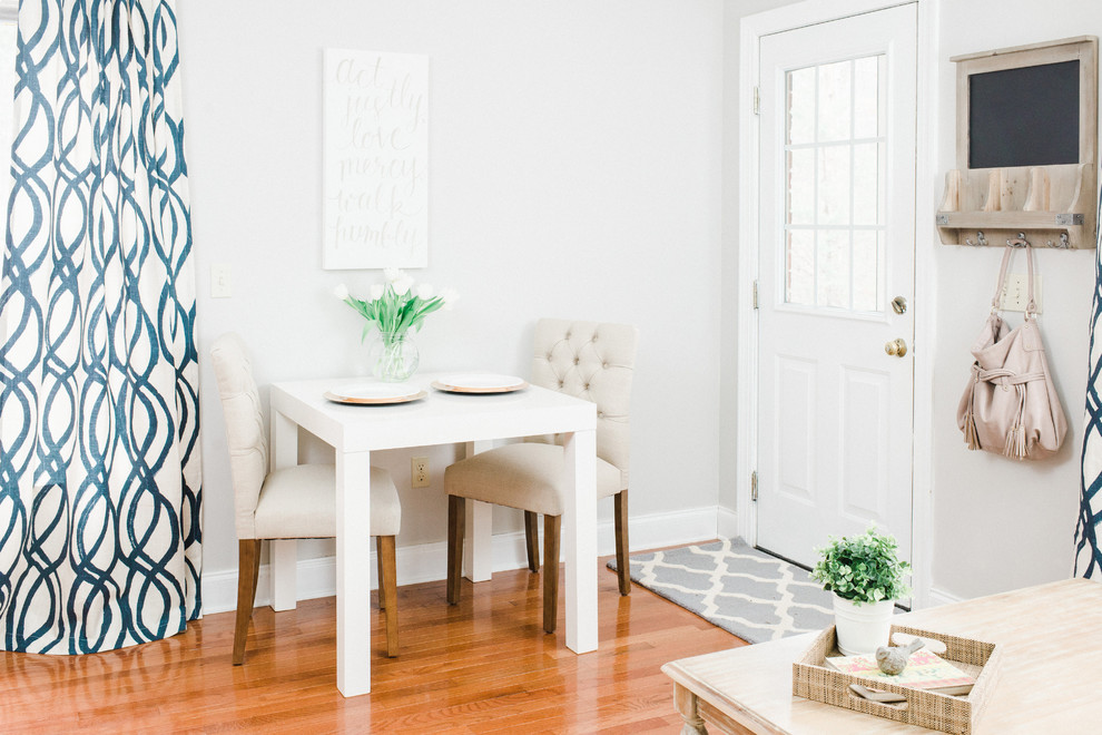 Dining room - traditional medium tone wood floor dining room idea in Grand Rapids with white walls