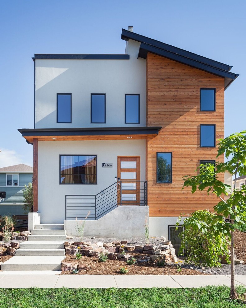 Photo of a contemporary two-storey white house exterior in Denver with mixed siding and a flat roof.