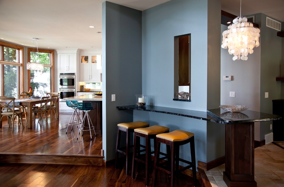 Inspiration for a small transitional medium tone wood floor and brown floor great room remodel with blue walls and no fireplace