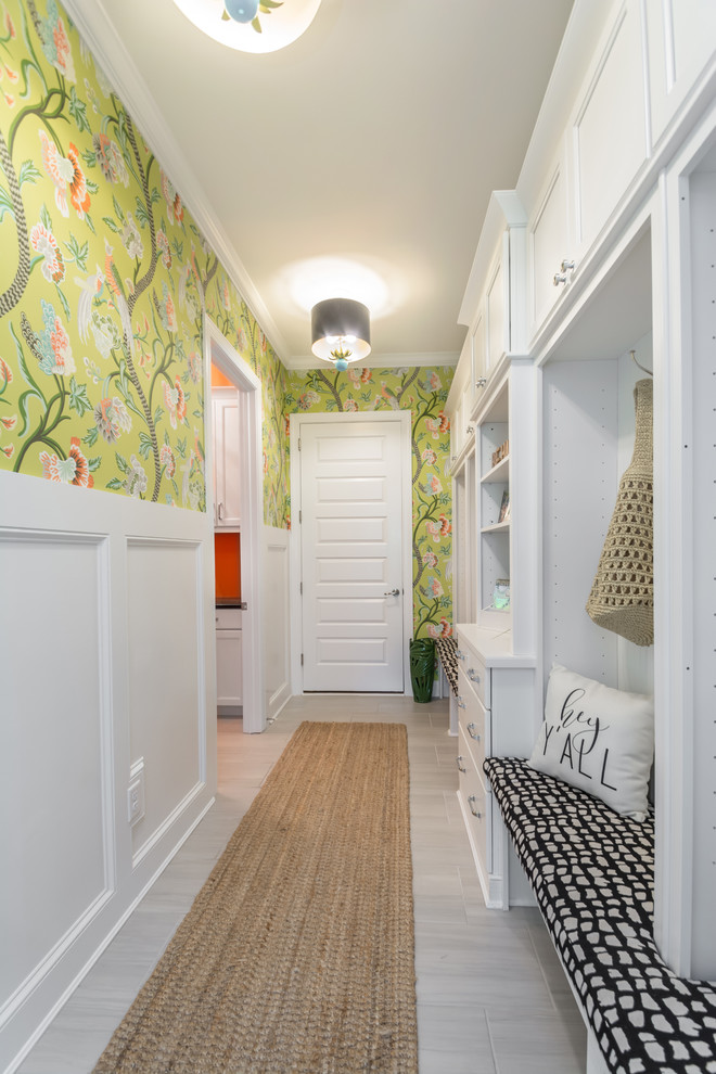 Design ideas for a transitional mudroom in Other with multi-coloured walls and grey floor.
