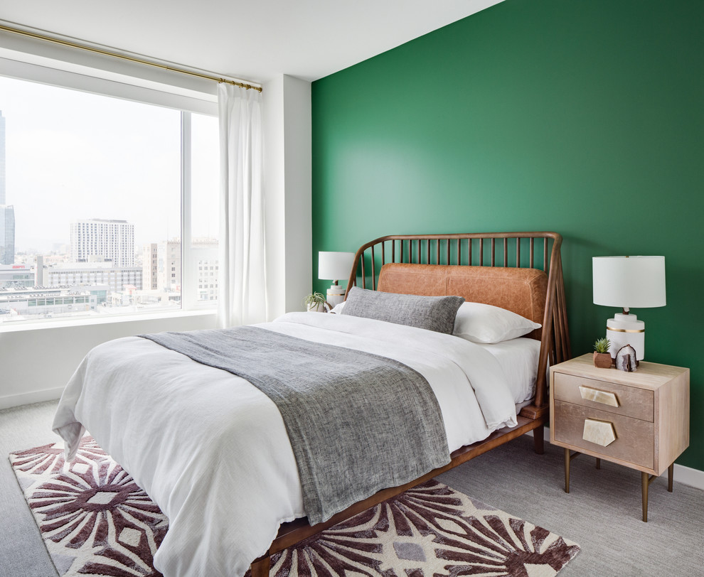 Design ideas for a large midcentury guest bedroom in Los Angeles with green walls, carpet and grey floor.