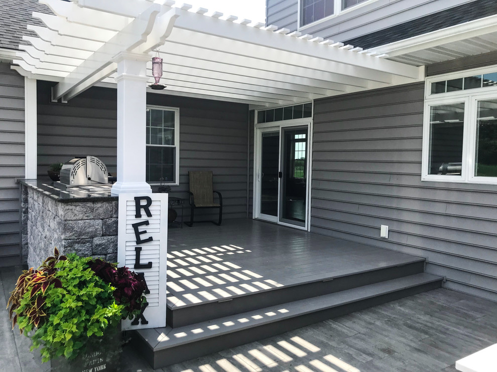 Mid-sized backyard outdoor kitchen deck photo with a pergola