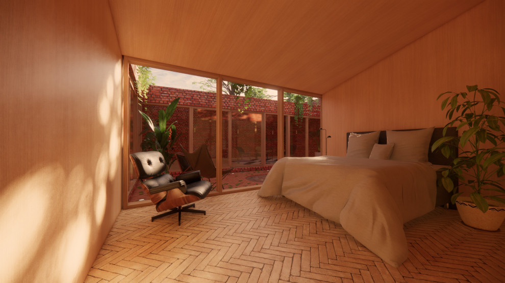 Photo of a small modern guest bedroom in Other with orange walls, brick floors, no fireplace and beige floor.