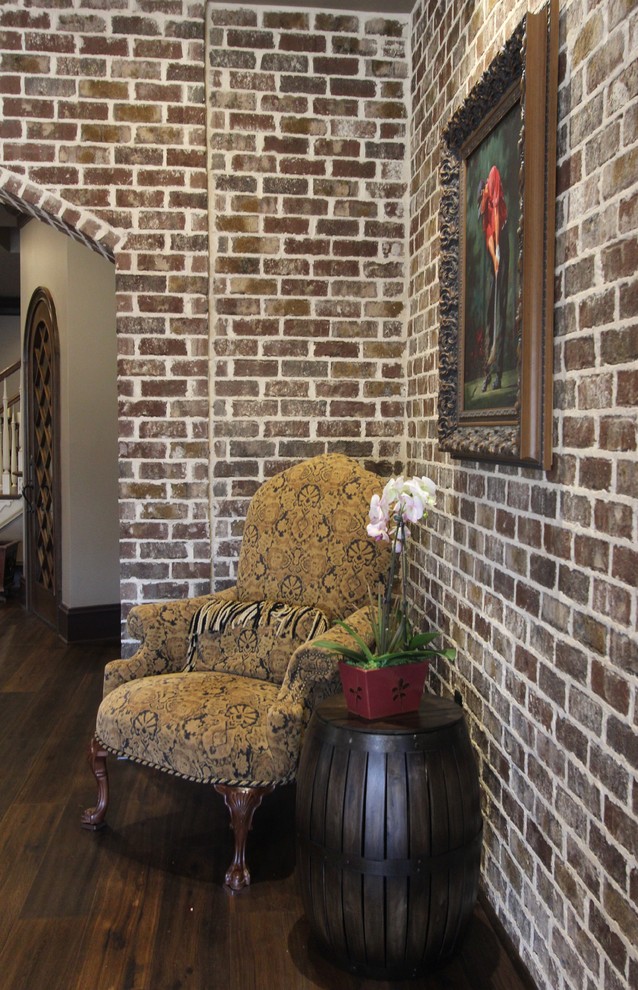 Basement - huge transitional walk-out medium tone wood floor basement idea with brown walls, a two-sided fireplace and a stone fireplace