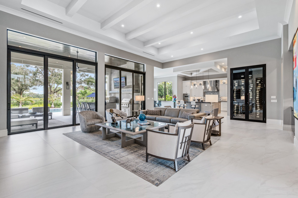 Inspiration for a large modern open concept living room in Miami with grey walls, porcelain floors, a built-in media wall, white floor and coffered.