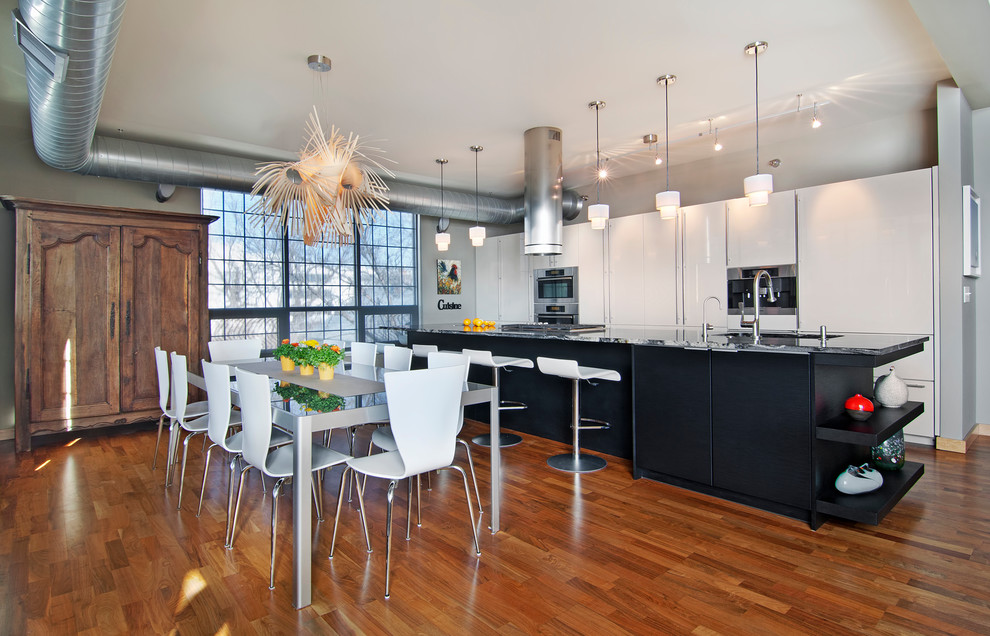 This is an example of a contemporary galley eat-in kitchen in Minneapolis with flat-panel cabinets and white cabinets.