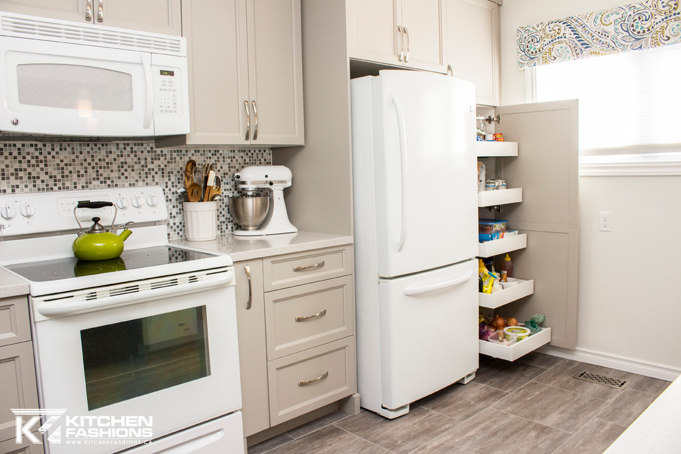 Mid-sized transitional single-wall ceramic tile open concept kitchen photo with an undermount sink, shaker cabinets, gray cabinets, solid surface countertops, gray backsplash, mosaic tile backsplash, white appliances and an island