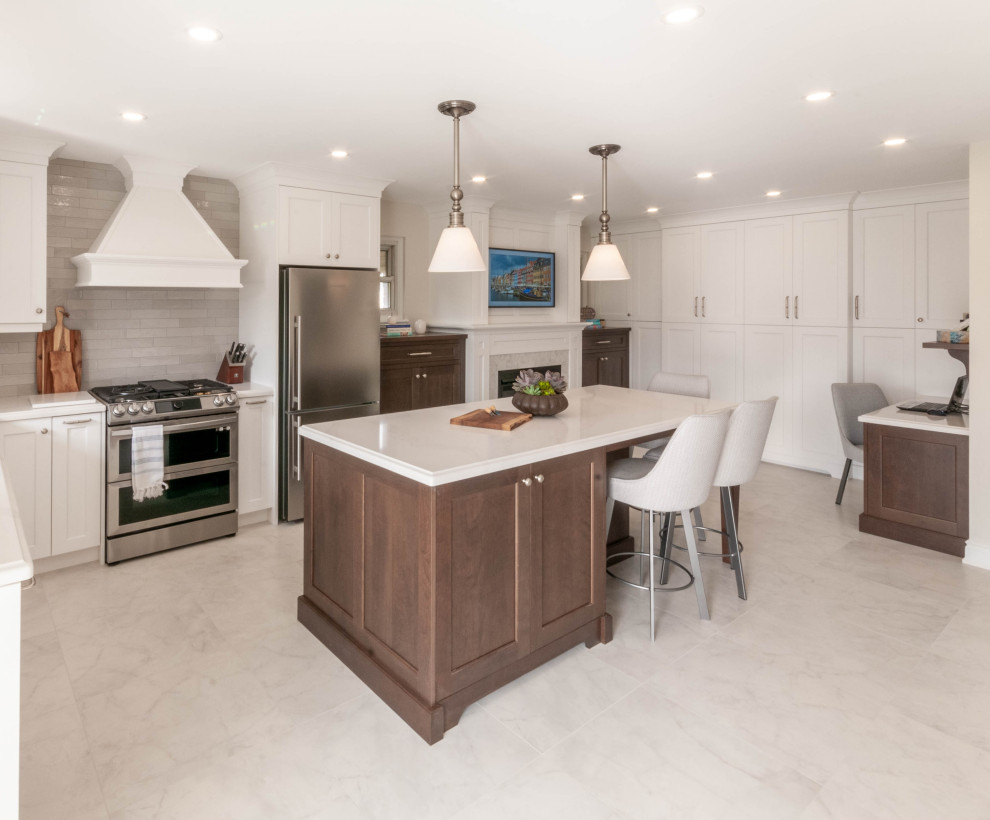 Eat-in kitchen - large transitional l-shaped porcelain tile and white floor eat-in kitchen idea in Toronto with an undermount sink, recessed-panel cabinets, white cabinets, quartz countertops, gray backsplash, ceramic backsplash, stainless steel appliances, an island and white countertops