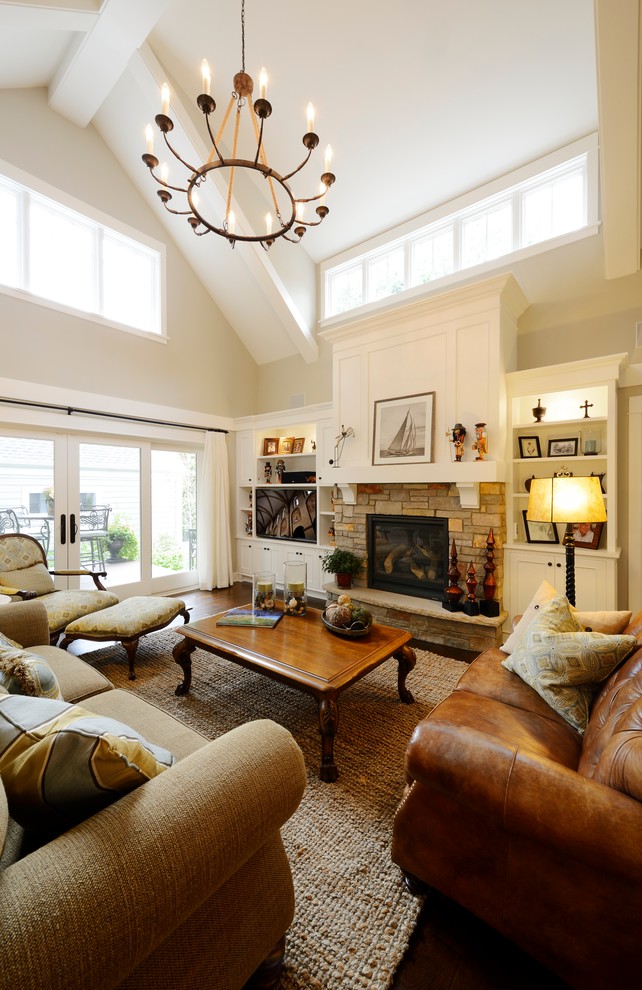 Inspiration for a traditional living room in Minneapolis with a standard fireplace and a stone fireplace surround.