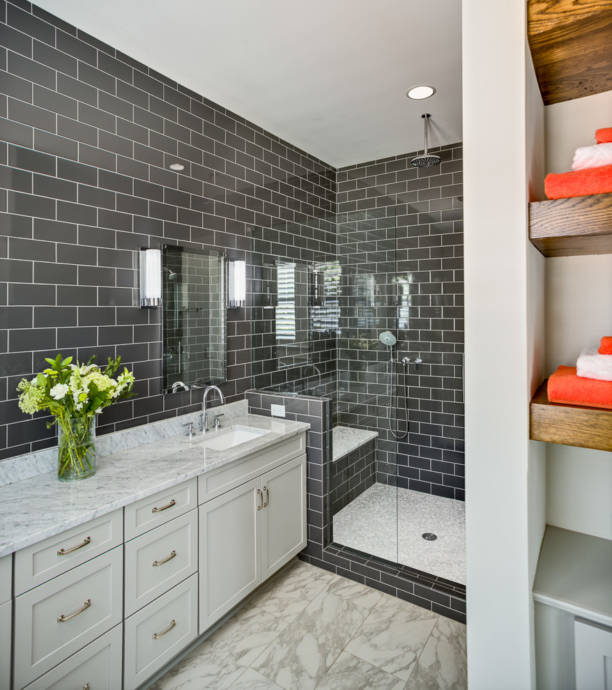 This is an example of a mid-sized arts and crafts master bathroom in Other with shaker cabinets, white cabinets, an alcove shower, a two-piece toilet, black tile, ceramic tile, black walls, ceramic floors, an undermount sink and marble benchtops.