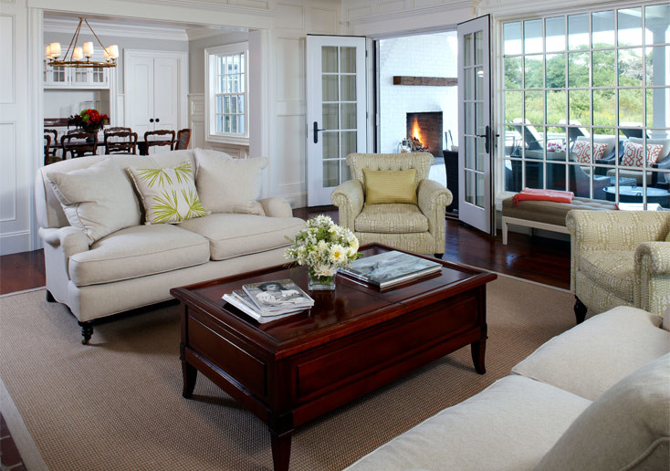 This is an example of a large beach style formal enclosed living room in Boston with white walls and dark hardwood floors.