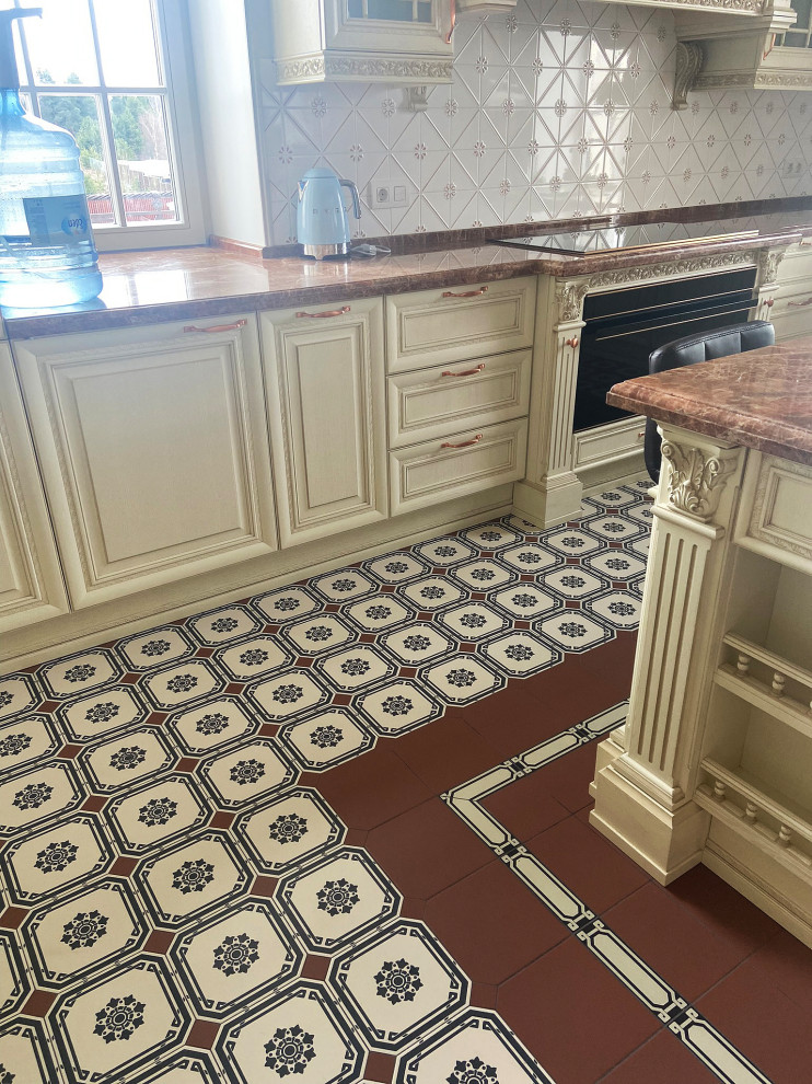 Inspiration for a victorian l-shaped multicolored floor eat-in kitchen remodel in Saint Petersburg with light wood cabinets, quartzite countertops, white backsplash, ceramic backsplash, red countertops, raised-panel cabinets, black appliances and an island