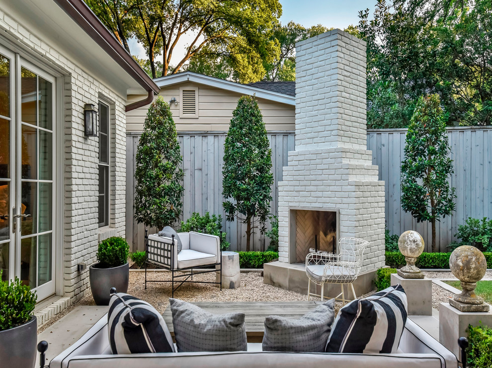 This is an example of a traditional backyard patio in Austin with gravel and no cover.