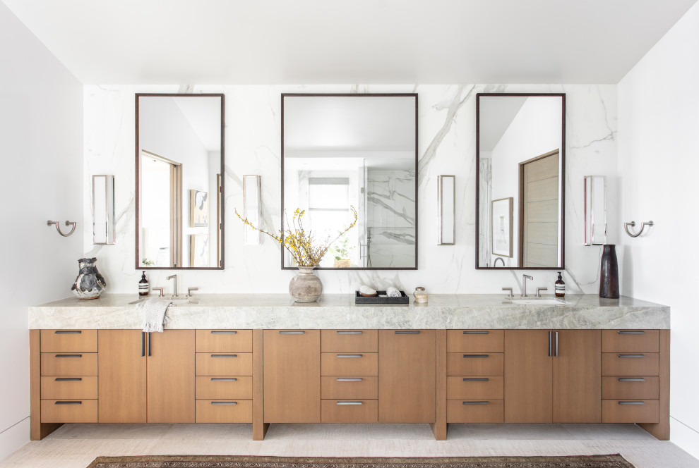 Trendy gray floor, double-sink and vaulted ceiling bathroom photo in Other with flat-panel cabinets, medium tone wood cabinets, white walls, an undermount sink, gray countertops and a built-in vanity