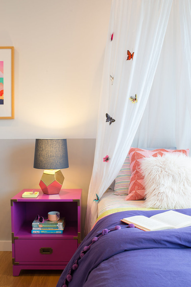 Contemporary kids' room in San Francisco with grey walls and medium hardwood floors for girls.