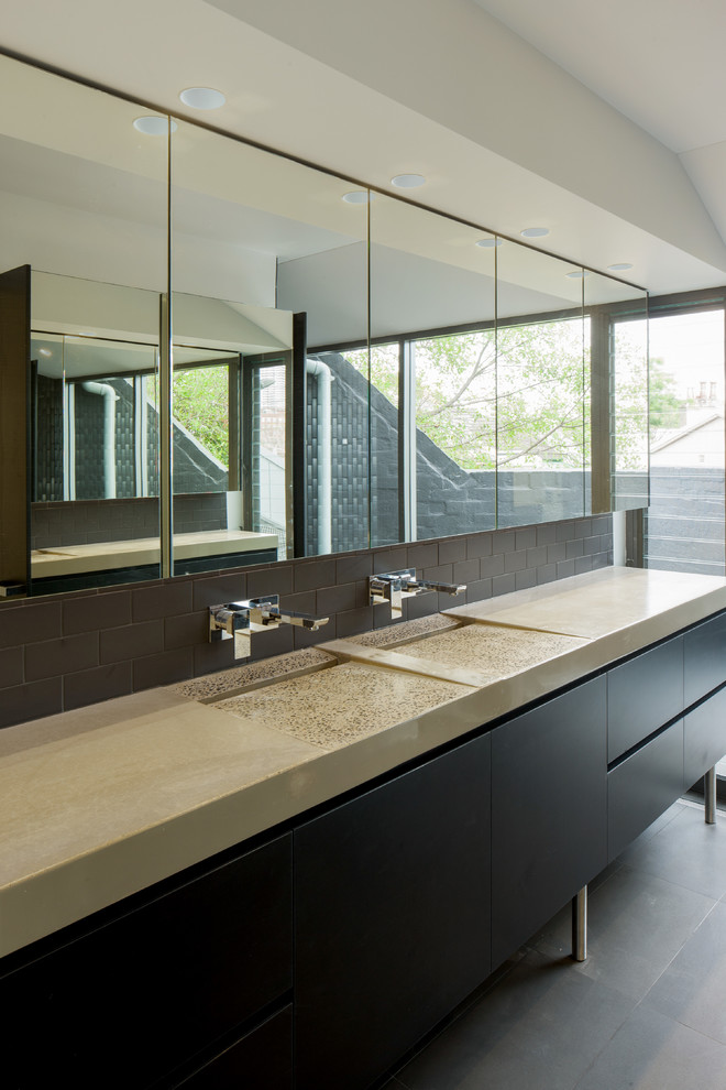 Design ideas for a mid-sized industrial master bathroom in Sydney with flat-panel cabinets, black cabinets, brown tile, cement tiles, an integrated sink, concrete benchtops and grey floor.