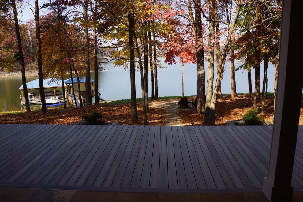 Inspiration for an expansive traditional backyard deck in Charlotte with an outdoor kitchen and a roof extension.