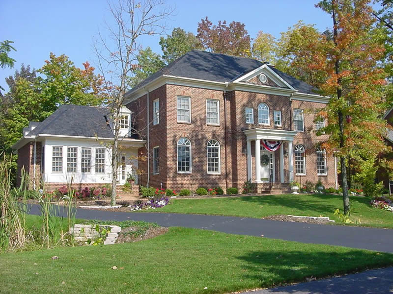 This is an example of a large traditional two-storey brick red exterior in Columbus.