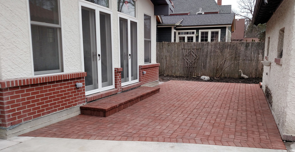 Design ideas for a small mediterranean backyard patio in Chicago with brick pavers.