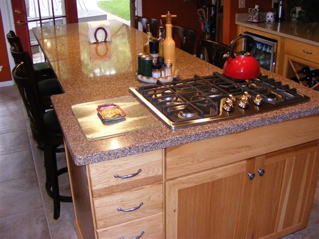 This is an example of a mid-sized country galley eat-in kitchen in Austin with raised-panel cabinets, light wood cabinets, solid surface benchtops, white appliances, ceramic floors and no island.