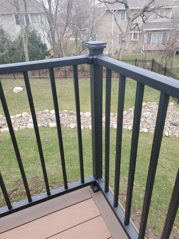Example of a large backyard second story metal railing deck design with no cover