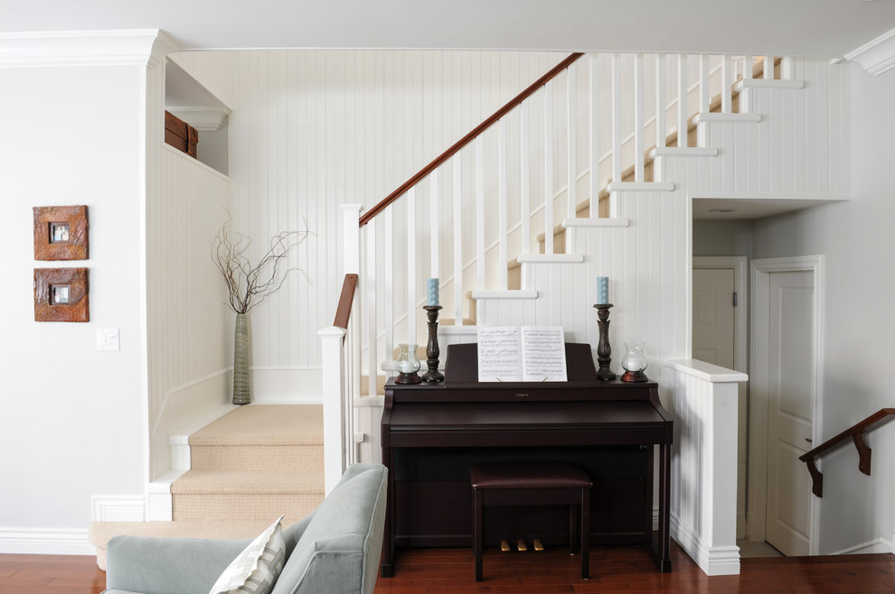 Inspiration for a small transitional painted wood straight staircase in Vancouver with painted wood risers.