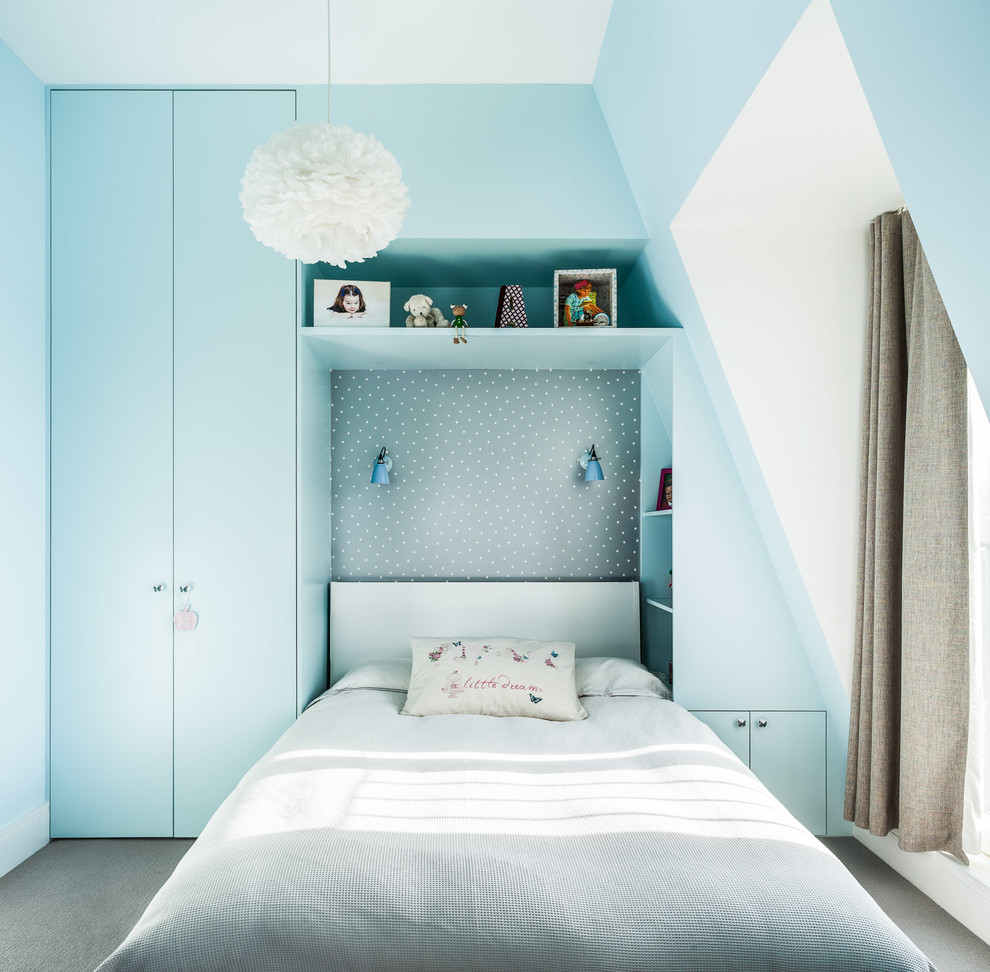 Contemporary kids' bedroom in London with blue walls and carpet for kids 4-10 years old and girls.